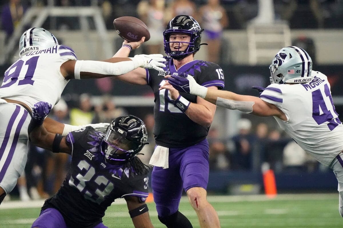 TCU quarterback Max Duggan (15) throws under pressure from Kansas State defensive end Felix Anu ...