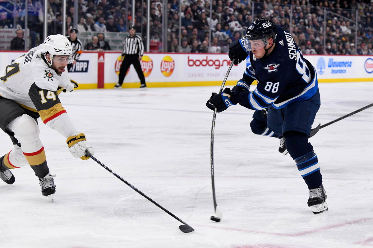 Winnipeg Jets' Nate Schmidt (88) takes a shot as Vegas Golden Knights' Nicolas Hague (14) defen ...