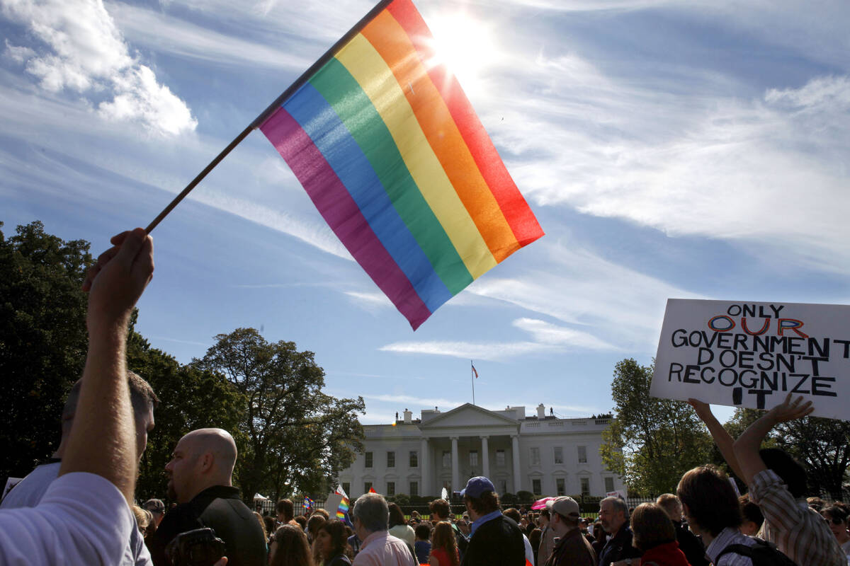 FILE - Gay rights advocates march by the White House in Washington, on Sunday, Oct. 11, 2009. P ...