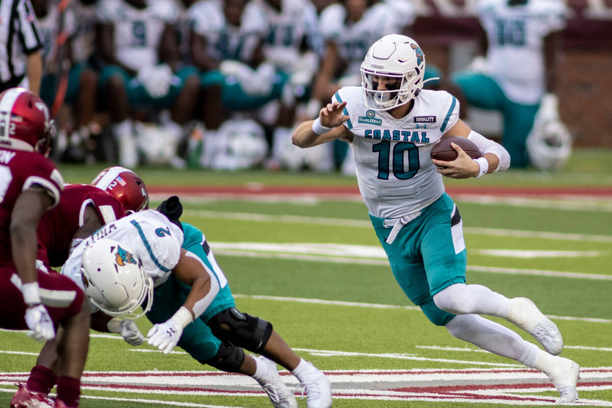 Coastal Carolina quarterback Grayson McCall (10) runs the ball against Troy during the first ha ...