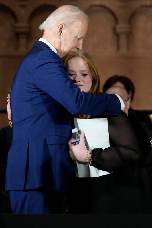 President Joe Biden hugs Sandy Hook survivor Jackie Hegarty, who introduced him, during an even ...