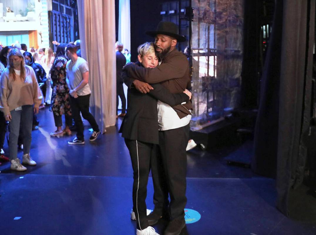 FILE - In this photo released by Warner Bros., talk show host Ellen DeGeneres embraces Stephen ...