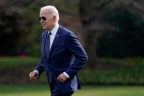 FILE - President Joe Biden jogs across the South Lawn of the White House to speak with visitors ...