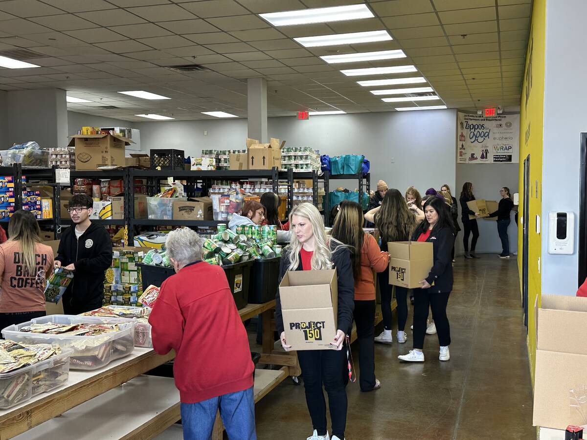 Formula One Las Vegas Grand Prix volunteers help fill holiday meal boxes for in need teenagers ...