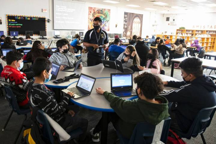 Cristian Calata, center, a substitute teacher at Bailey Middle School, works with three classes ...