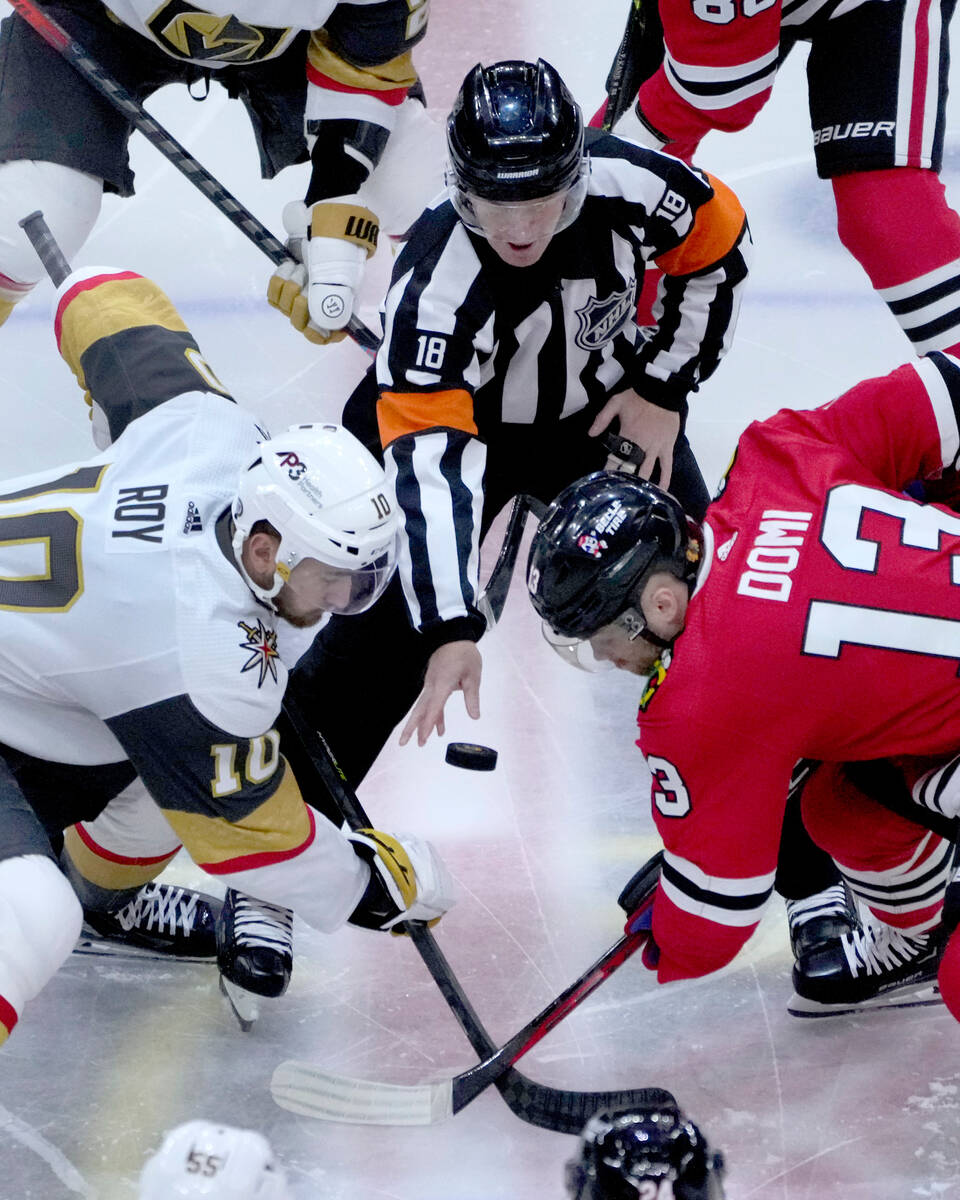 Referee Tom Chmielewski (18) drops the puck for the opening face-off between Vegas Golden Knigh ...