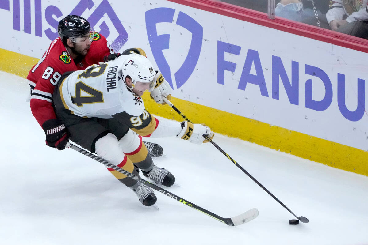 Chicago Blackhawks' Andreas Athanasiou (89) pressures Vegas Golden Knights' Brayden Pachal duri ...