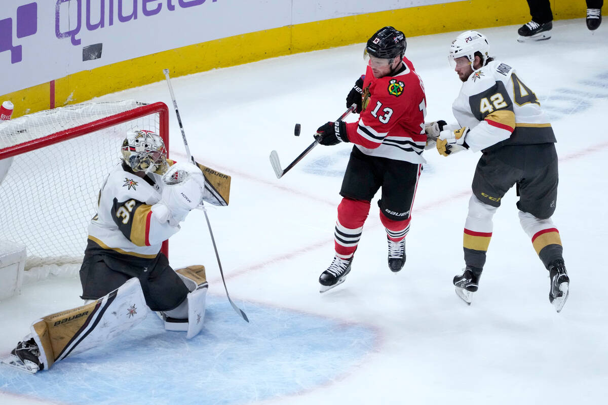 Chicago Blackhawks' Max Domi (13) takes a shot on goal as Vegas Golden Knights goaltender Logan ...