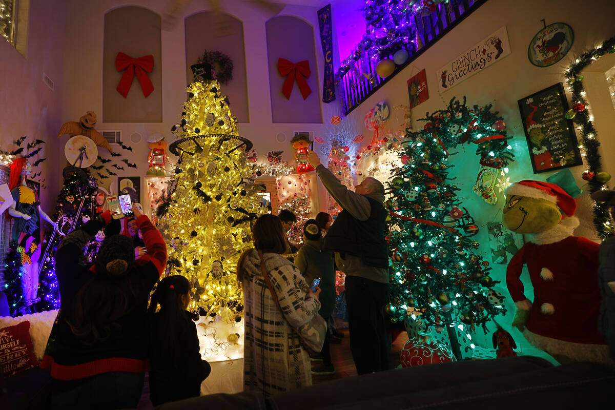 People visit the Candy Cane House, Friday, Dec. 16, 2022, in Henderson. Victor Cardenas and his ...