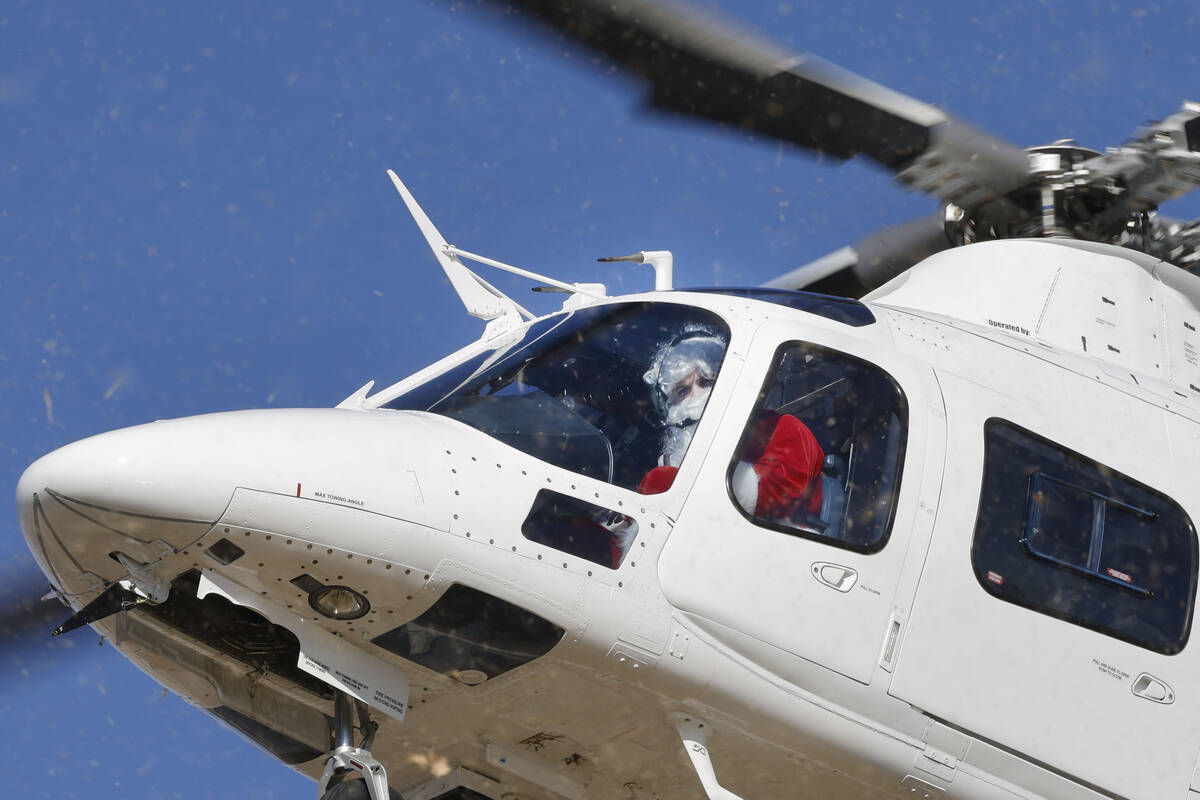 Santa Claus arrives at Fay Herron Elementary School by helicopter, Thursday, Dec. 15, 2022, in ...