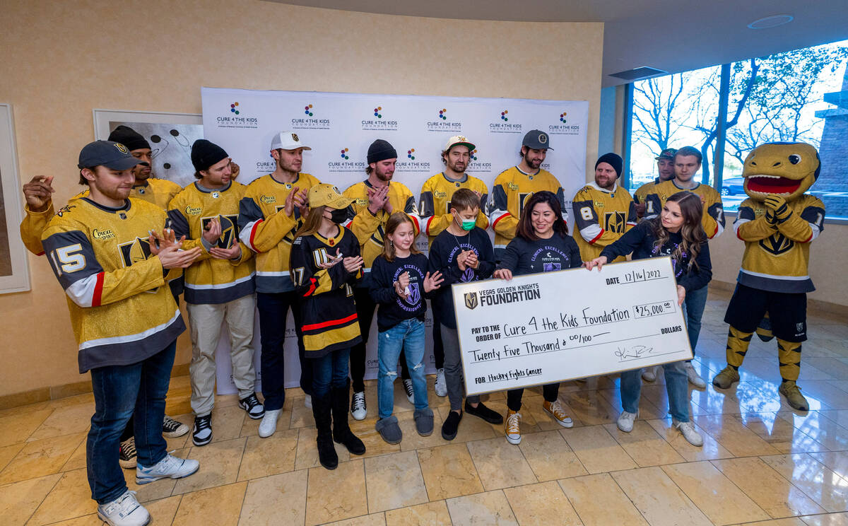 The Cure 4 The Kids Foundation receive a check by the Vegas Golden Knights Foundation as player ...