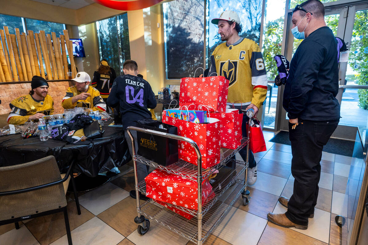 Mark Stone (61) delivers gifts as the Cure 4 The Kids Foundation are joined by Golden Knights p ...