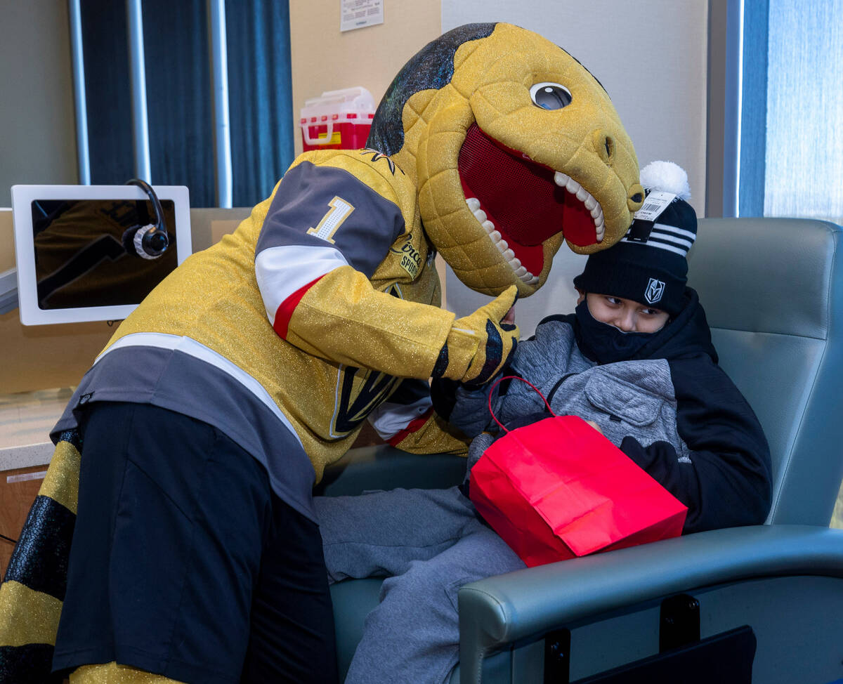 Chance the Gila monster poses for a picture with patient Johnathan Mejia, 11, as the Cure 4 The ...