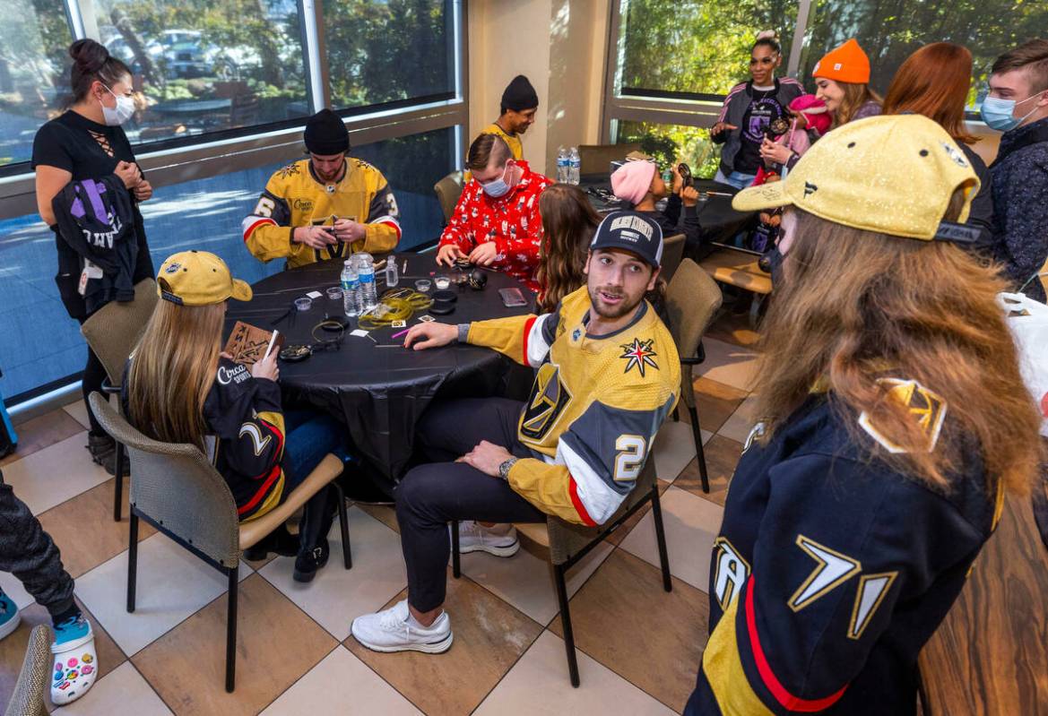 Shea Theodore (27) talks with Cindy Christy while her daughter Louisa, 14, left, joins others a ...