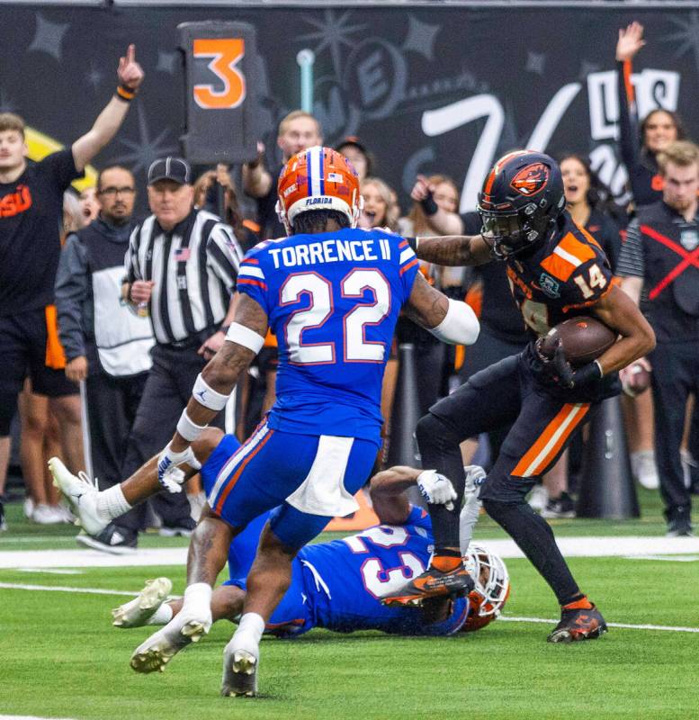 Oregon State Beavers wide receiver John Dunmore (14) is stopped short by Florida Gators cornerb ...