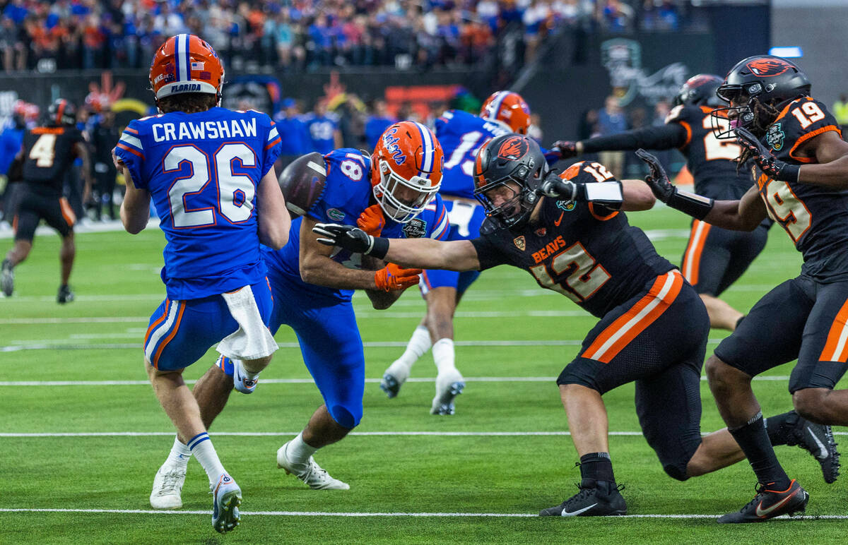 Florida Gators punter Jeremy Crawshaw (26) has a kick blocked into teammate Florida Gators tigh ...