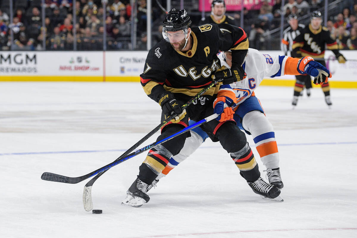 New York Islanders left wing Anders Lee (27) tries to get the puck from Vegas Golden Knights de ...