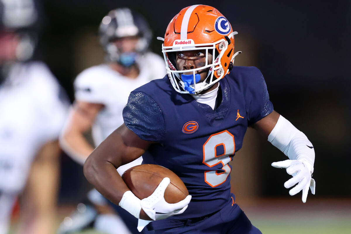 FILE - Bishop Gorman's Elija Lofton (9) runs the ball against Corner Canyon during the first ha ...