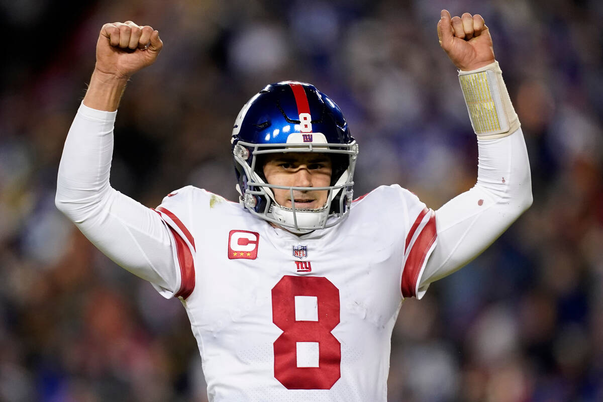 New York Giants quarterback Daniel Jones (8) celebrates a touchdown by running back Saquon Bark ...