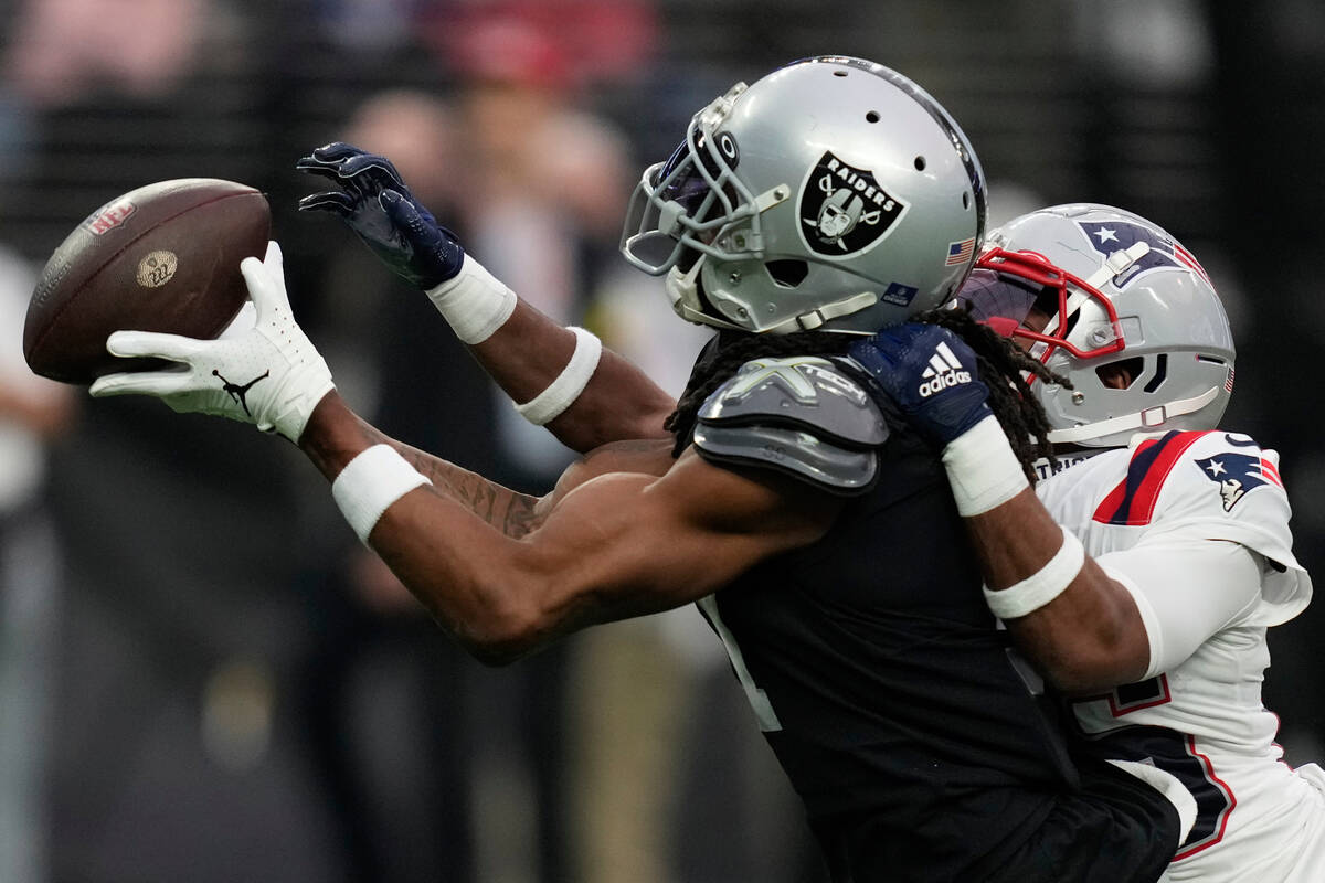 New England Patriots cornerback Marcus Jones (25) breaks up a pass intended for Las Vegas Raide ...