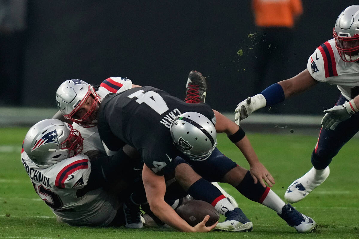 Las Vegas Raiders quarterback Derek Carr (4) is sacked during the second half of an NFL footbal ...