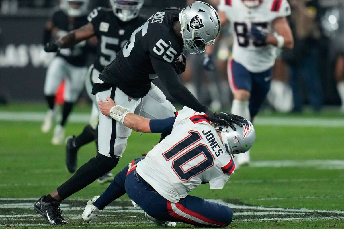 Las Vegas Raiders defensive end Chandler Jones (55) breaks a tackle by New England Patriots qua ...