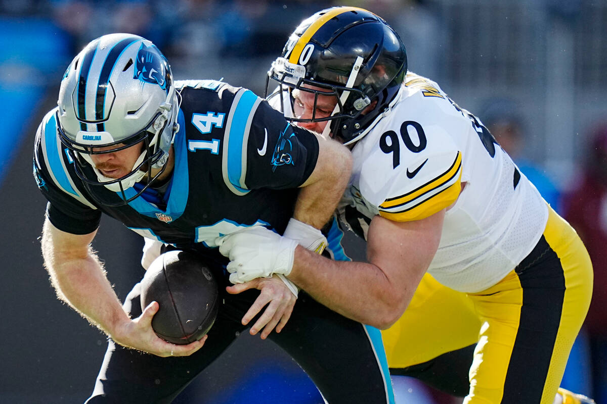 Carolina Panthers quarterback Sam Darnold is sacked by Pittsburgh Steelers linebacker T.J. Watt ...