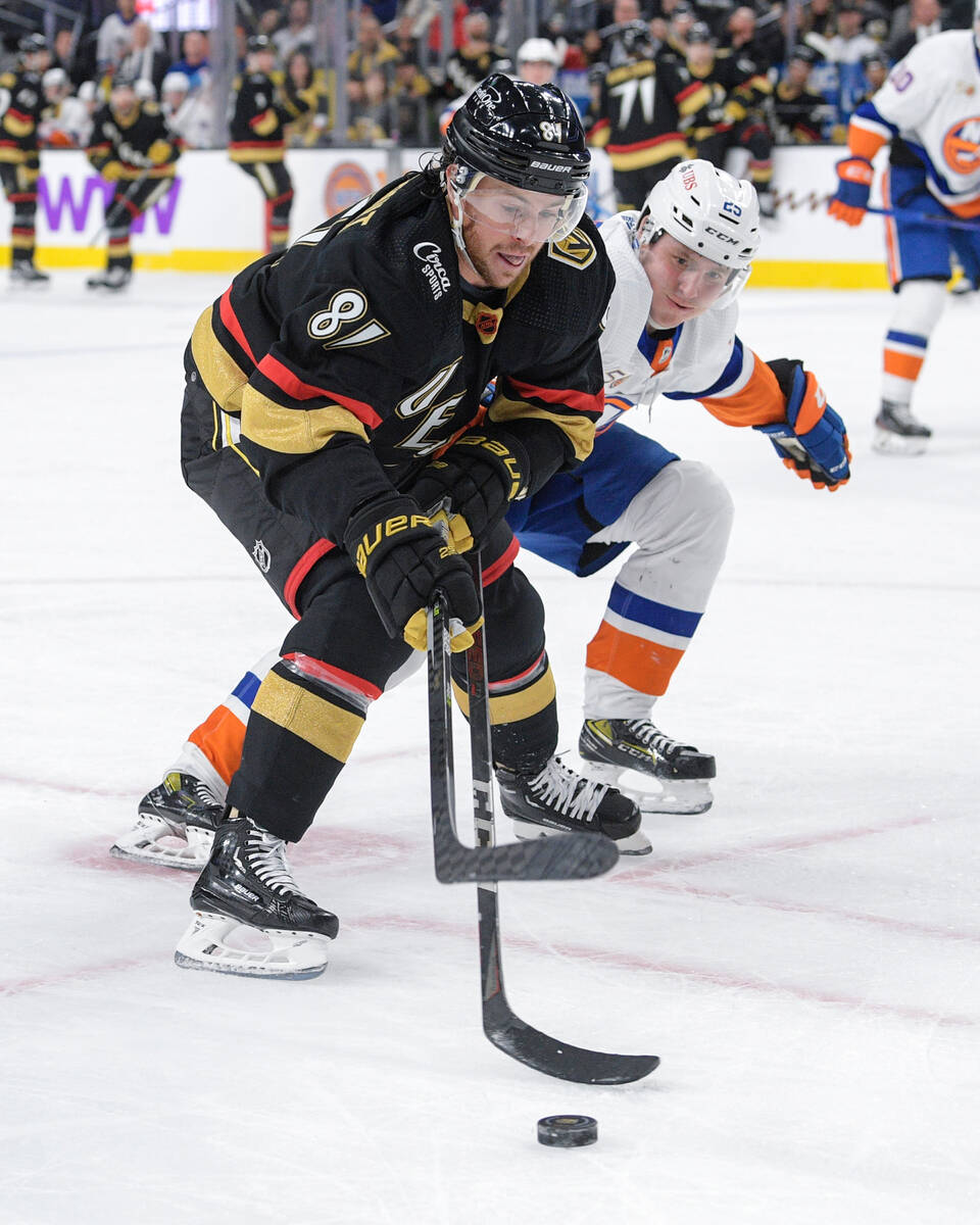 Vegas Golden Knights center Jonathan Marchessault (81) and keeps the puck away from New York Is ...