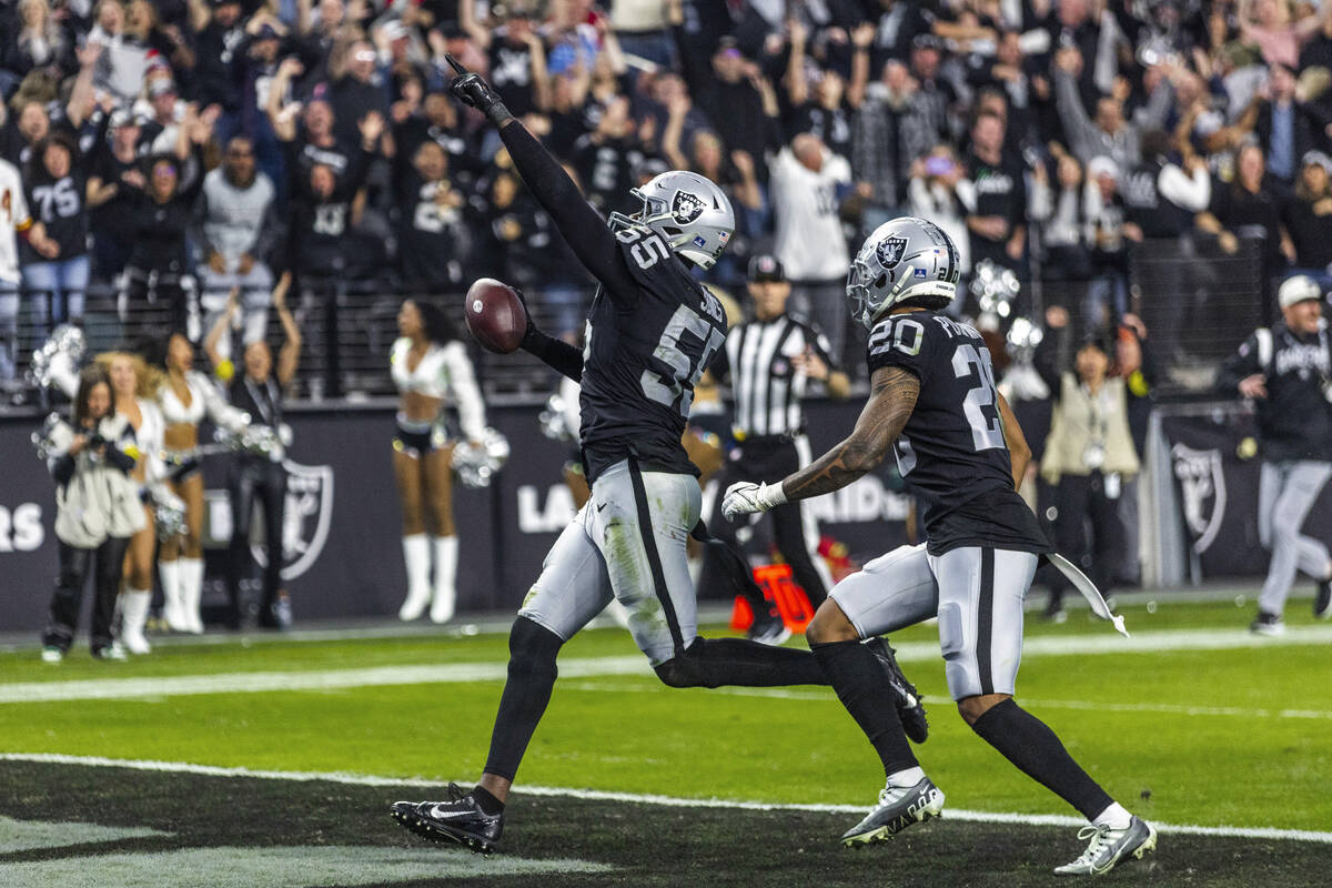 Raiders defensive end Chandler Jones (55) celebrates as he scores a game-winning touchdown over ...