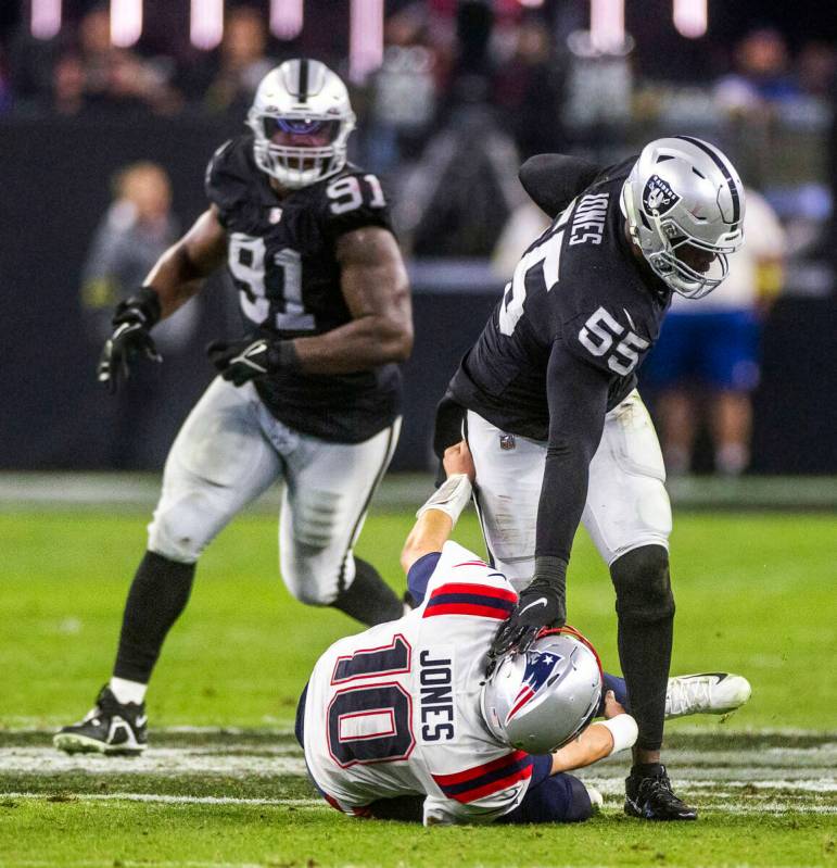 Raiders defensive end Chandler Jones (55) dives New England Patriots quarterback Mac Jones (10) ...