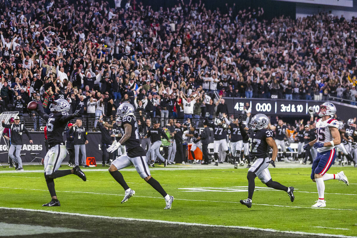 Raiders defensive end Chandler Jones (55) celebrates as he scores a game-winning touchdown over ...