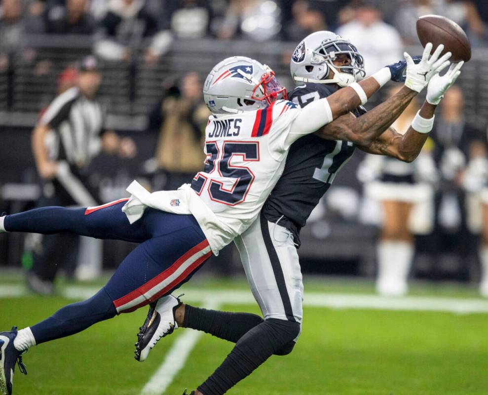 New England Patriots cornerback Marcus Jones (25) defends a pass intended for Raiders wide rece ...