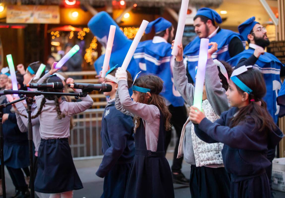 Desert Torah Academy Children’s Choir perform with the Dancing Dreidels during a celebra ...