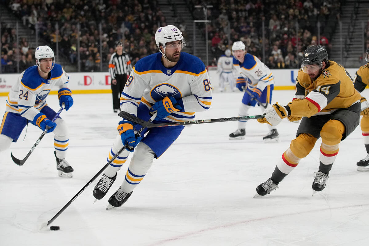 Buffalo Sabres right wing Alex Tuch (89) skates around Vegas Golden Knights defenseman Nicolas ...