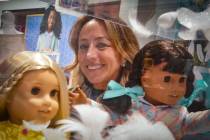 Jamie Cygielman, general manager and president at American Girl, poses behind a showcase of dol ...