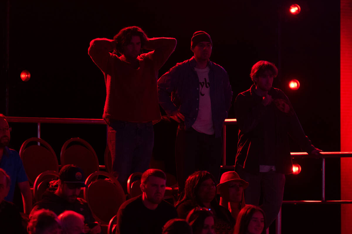 People watch players in the final table of the World Poker Tour World Championship at the Wynn ...