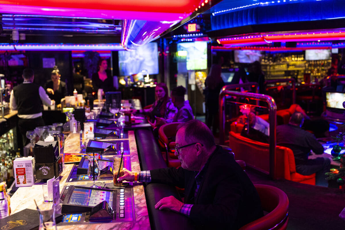 A customers plays a tabletop game with a drink at Peppermill on Tuesday, Dec. 13, 2022, in Las ...