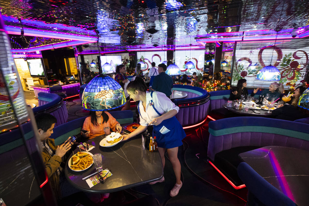 Waitresses Haleigh Bilesimo serves customers at Peppermill on Wednesday, Dec. 14, 2022, in Las ...
