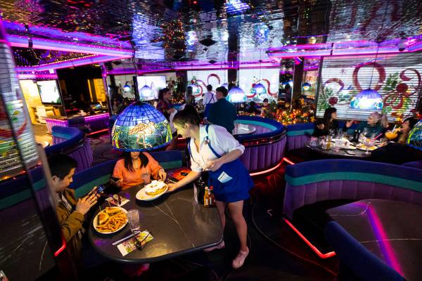 Waitresses Haleigh Bilesimo serves customers at Peppermill on Wednesday, Dec. 14, 2022, in Las ...