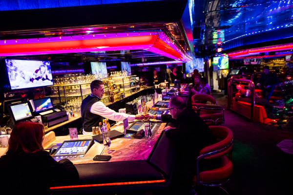 Bartender Kyle Tomsic serves a customer in the Fireside Lounge at Peppermill on Tuesday, Dec. 1 ...