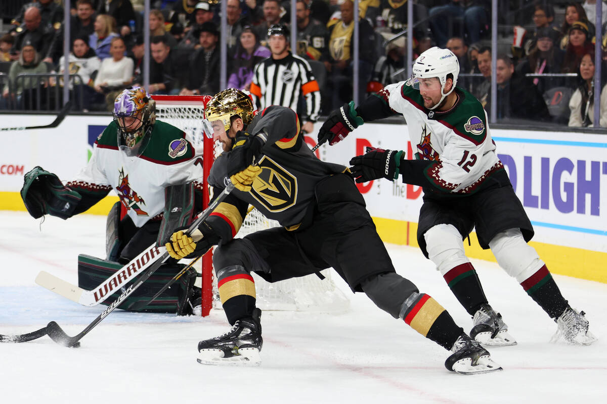 Vegas Golden Knights center Nicolas Roy (10) looks for an open shot under pressure from Arizona ...