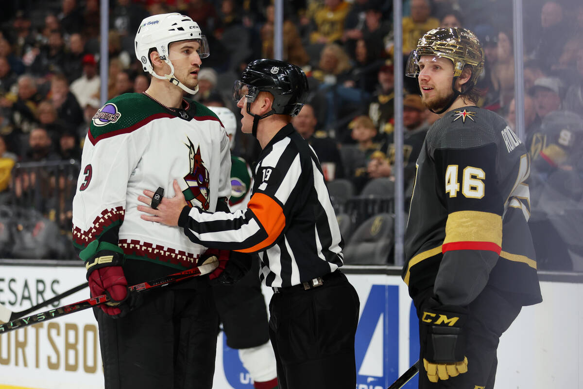 The referee gets in between Arizona Coyotes defenseman Josh Brown (3) and Vegas Golden Knights ...