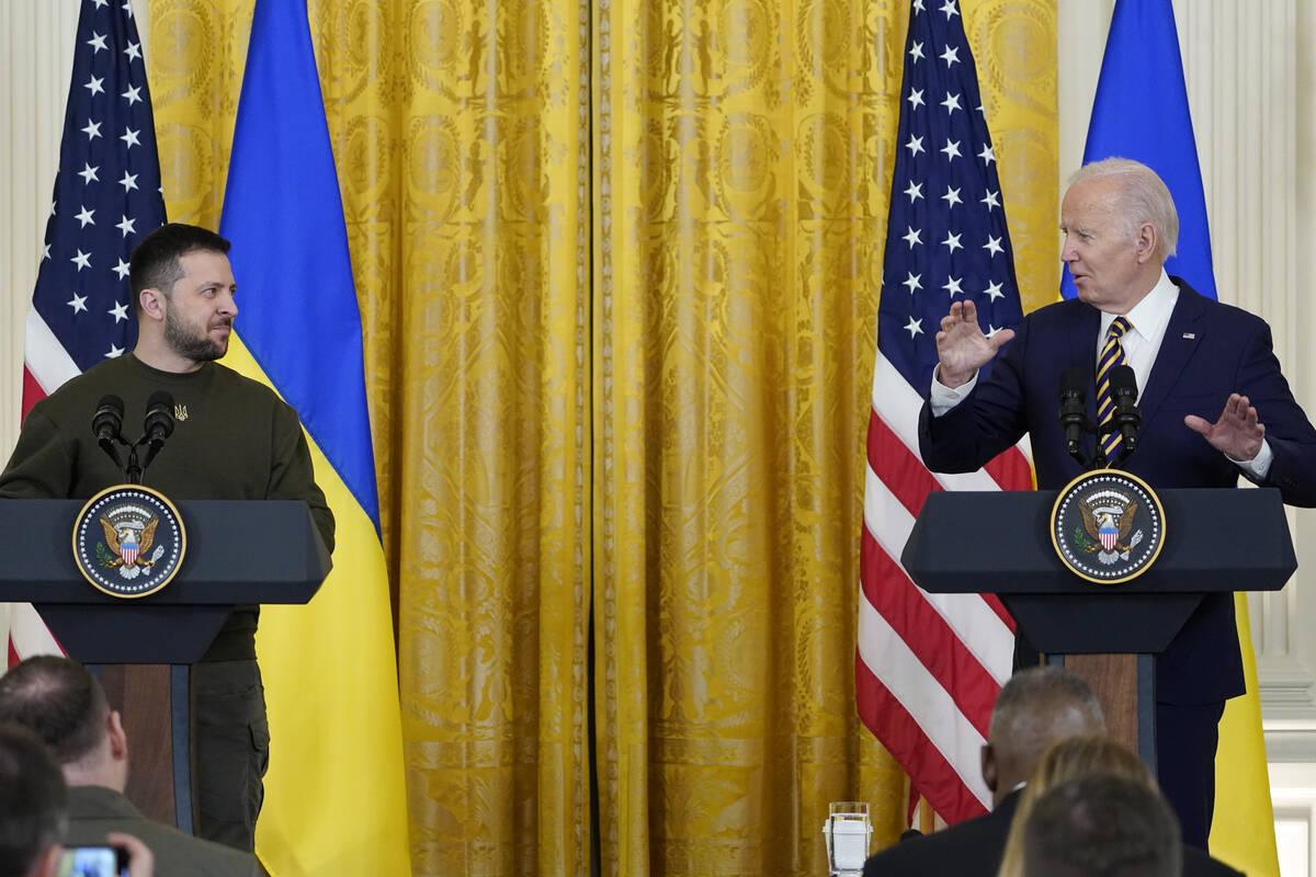 Ukrainian President Volodymyr Zelenskyy listens as President Joe Biden speaks during a news con ...