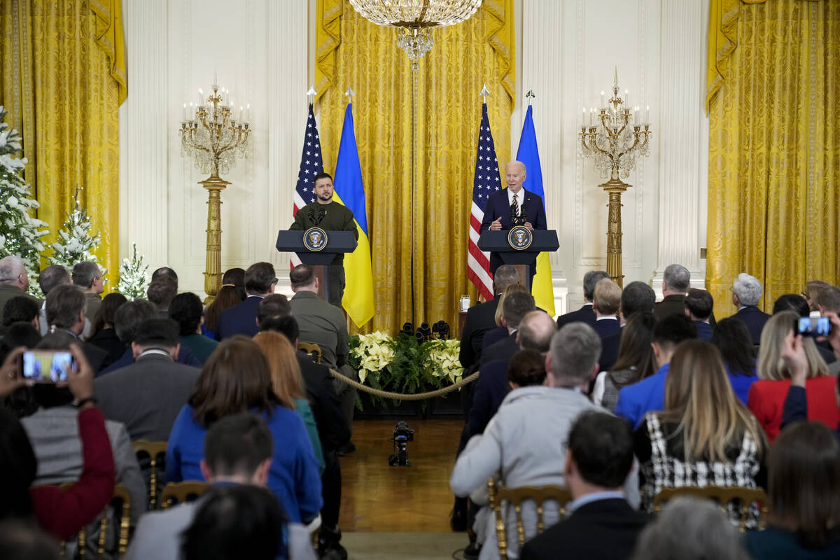 Ukrainian President Volodymyr Zelenskyy listens as speaks President Joe Biden during a news con ...