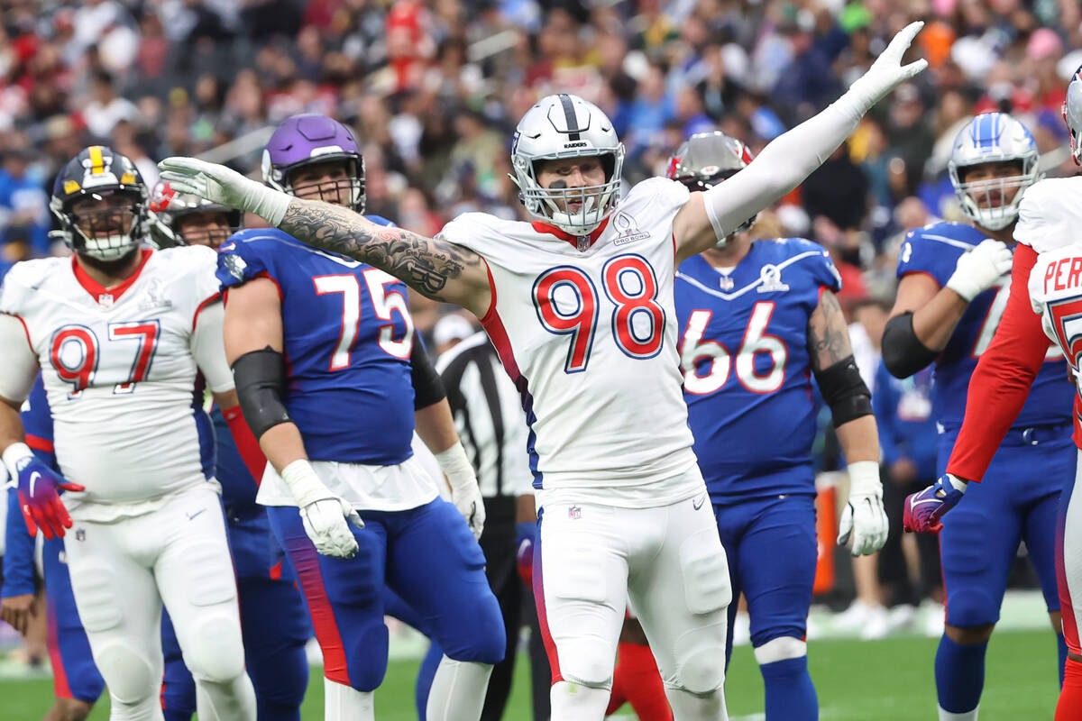 AFC defensive end Maxx Crosby of the Las Vegas Raiders (98) celebrates after blocking a pass fr ...