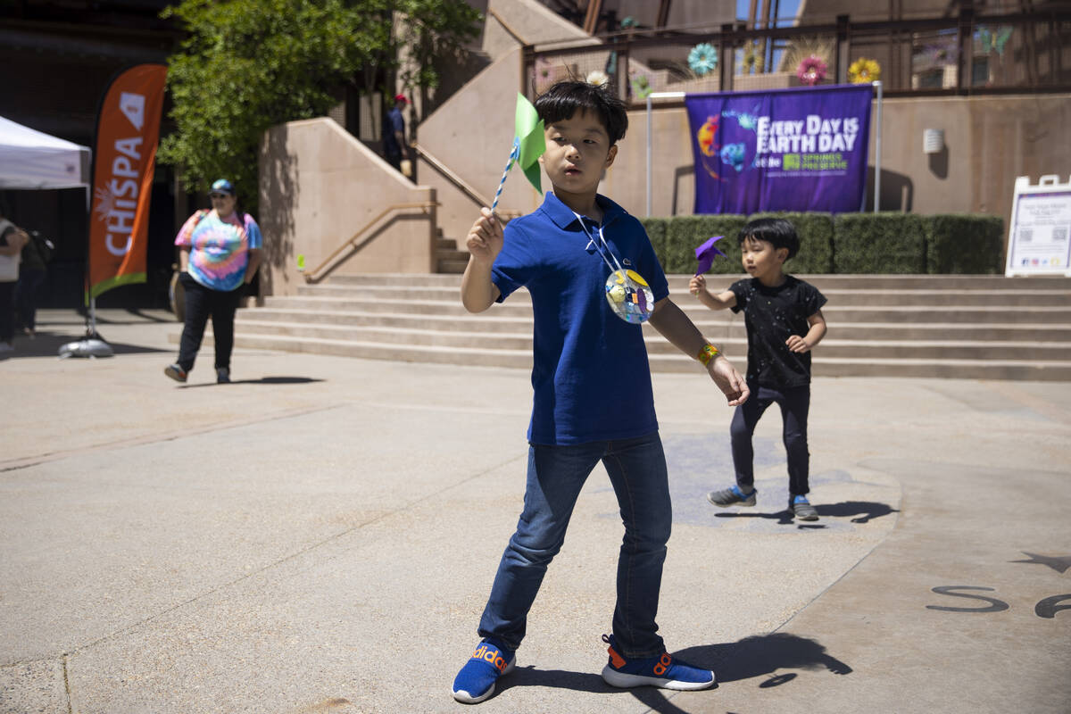 Siblings Joonhee Shin, 7, left, and Royhee Shin, 4, play during an Earth Day celebration at Spr ...