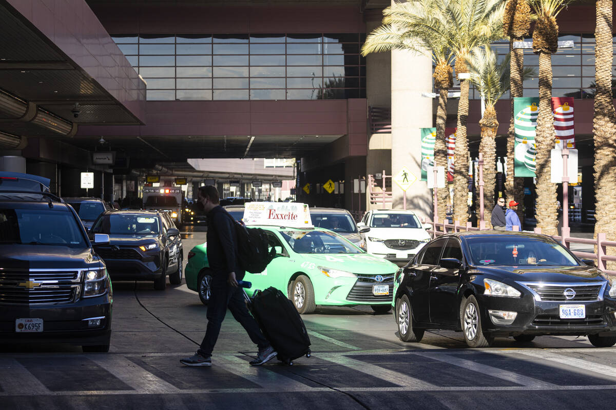 Passengers are dropped off at Harry Reid International Airport on Thursday, Dec. 22, 2022, in L ...