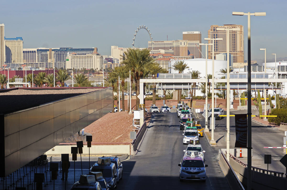 Taxis line up in a queue at Harry Reid International Airport on Thursday, Dec. 22, 2022, in Las ...