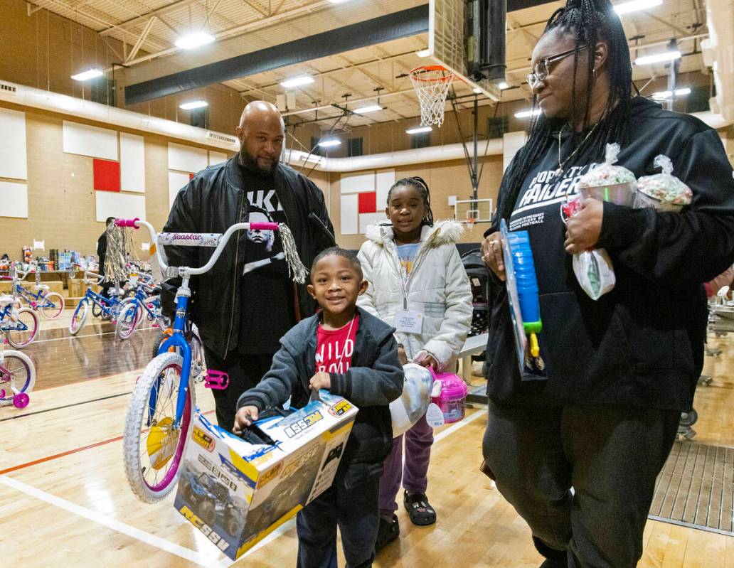 Brandon Soriaga, 4, and his sister Leilani, 8, center, leave Pearson Community Center with thei ...