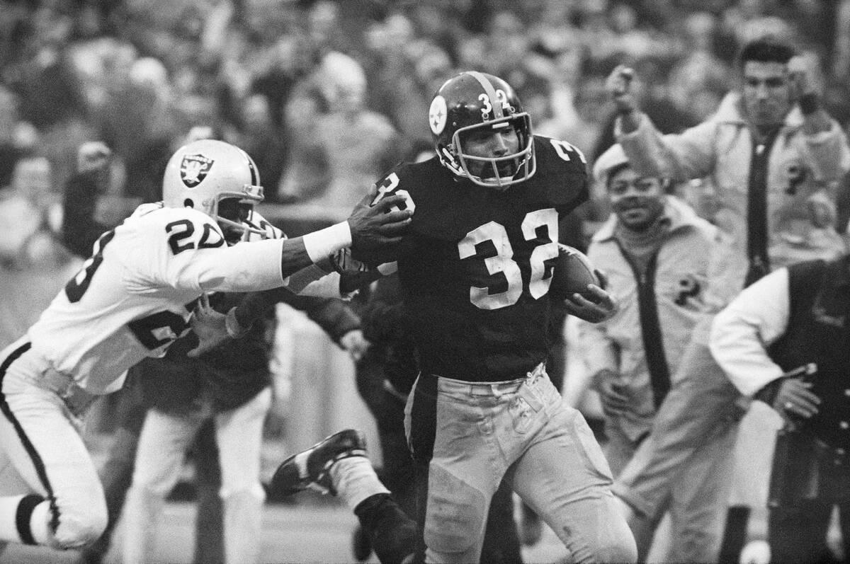 FILE - Pittsburgh Steelers' Franco Harris (32) eludes a tackle by Oakland Raiders' Jimmy Warren ...